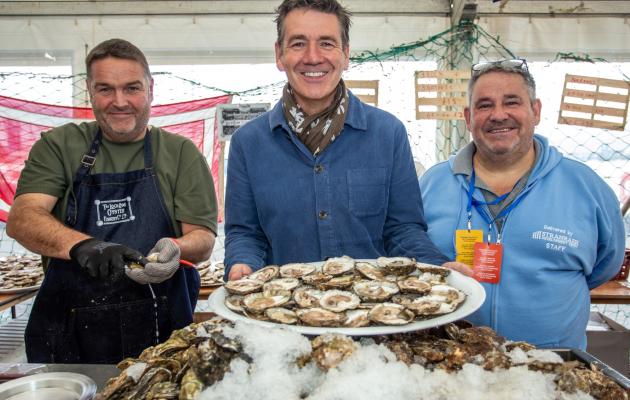 Three people at an oyster bar