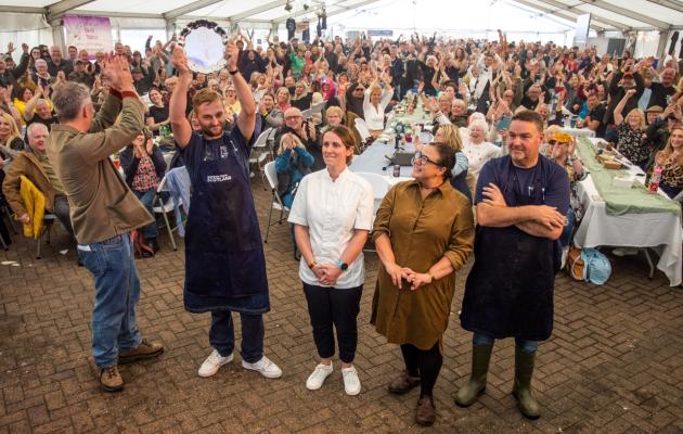 A crowd of people in a marquee