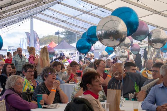 Visitors Enjoying Music in the Entertainment Marquee