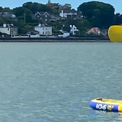 Two girls stand up paddle boarding at Loch Ryan